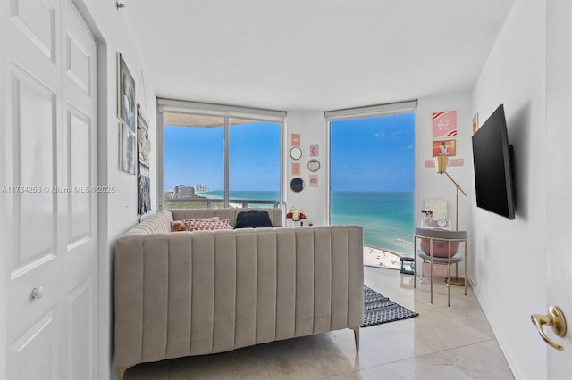7330 Ocean Ter Unit 20-B, Miami Beach, FL 33141 - living room featuring light tile patterned floors, expansive windows, and baseboards