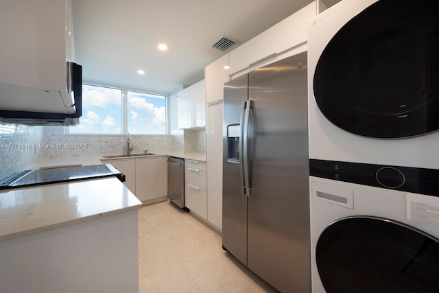 333 Sunset Dr Unit 804, Fort Lauderdale, FL 33301 - kitchen with tasteful backsplash, visible vents, stacked washer / dryer, appliances with stainless steel finishes, and a sink