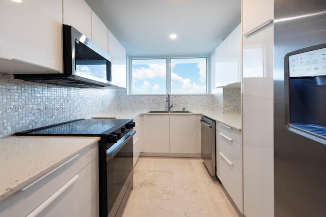 333 Sunset Dr Unit 804, Fort Lauderdale, FL 33301 - kitchen featuring appliances with stainless steel finishes, decorative backsplash, a sink, and modern cabinets