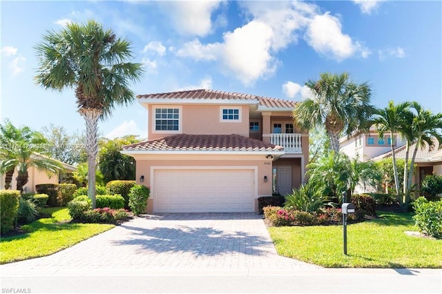 19726 Tesoro Way, Estero, FL 33967 - mediterranean / spanish house featuring a garage, a front lawn, decorative driveway, stucco siding, and a tile roof