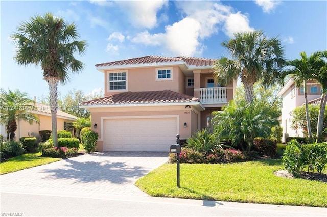 19726 Tesoro Way, Estero, FL 33967 - mediterranean / spanish-style house with decorative driveway, stucco siding, a tiled roof, and a front yard