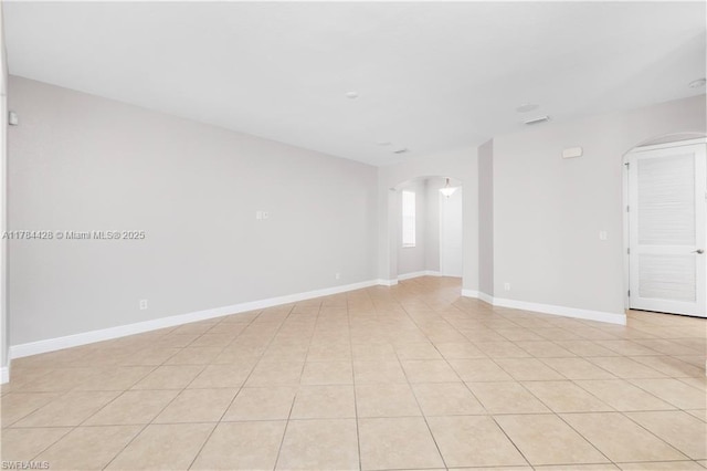 19726 Tesoro Way, Estero, FL 33967 - spare room featuring arched walkways and baseboards