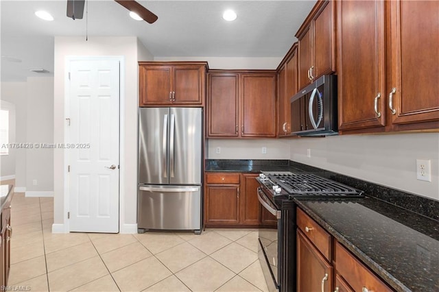 19726 Tesoro Way, Estero, FL 33967 - kitchen with light tile patterned floors, dark stone counters, a ceiling fan, and stainless steel appliances