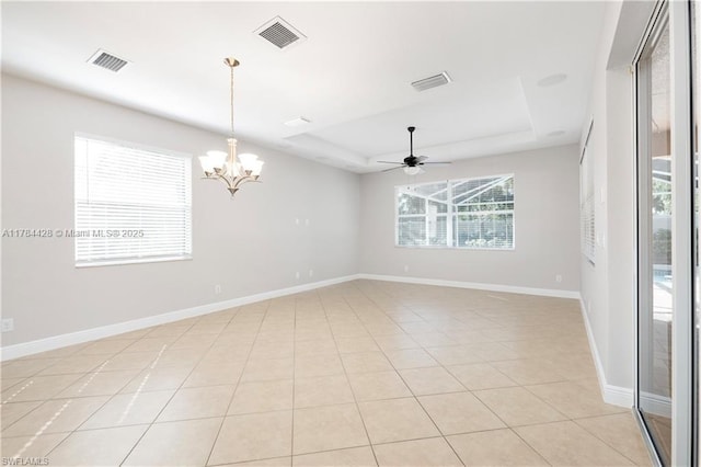 19726 Tesoro Way, Estero, FL 33967 - spare room with ceiling fan with notable chandelier, light tile patterned floors, a tray ceiling, and visible vents