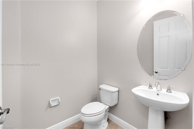 19726 Tesoro Way, Estero, FL 33967 - half bathroom featuring a sink, baseboards, tile patterned floors, and toilet