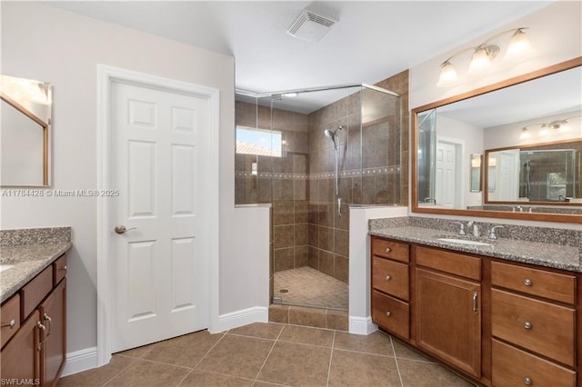19726 Tesoro Way, Estero, FL 33967 - full bath with visible vents, tile patterned flooring, a shower stall, vanity, and baseboards