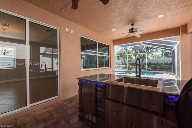 19726 Tesoro Way, Estero, FL 33967 - view of patio with visible vents, a lanai, ceiling fan, and exterior kitchen