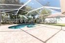 19726 Tesoro Way, Estero, FL 33967 - indoor pool featuring a patio area