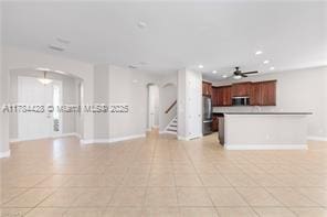 19726 Tesoro Way, Estero, FL 33967 - unfurnished living room with arched walkways, a ceiling fan, recessed lighting, baseboards, and stairway