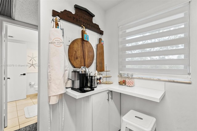 kitchen featuring tile patterned floors and light countertops