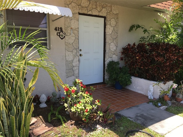 419 SW Natura Ave Unit C, Deerfield Beach, FL 33441 - view of exterior entry featuring stucco siding and stone siding