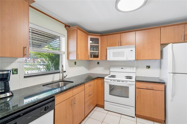 419 SW Natura Ave Unit C, Deerfield Beach, FL 33441 - kitchen with white appliances, decorative backsplash, dark stone counters, and glass insert cabinets