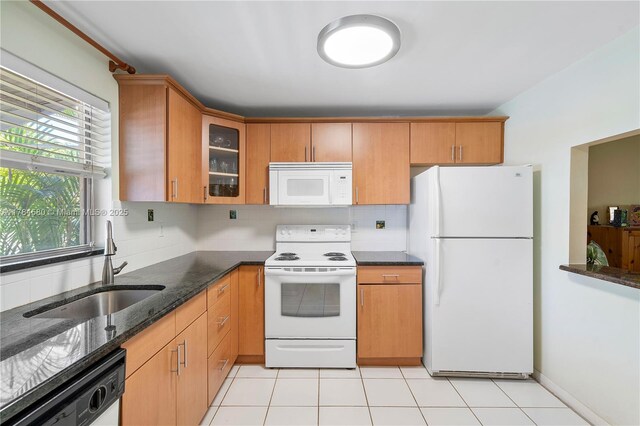 419 SW Natura Ave Unit C, Deerfield Beach, FL 33441 - kitchen featuring white appliances, backsplash, dark stone countertops, and glass insert cabinets