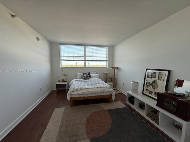 bedroom featuring baseboards and wood finished floors