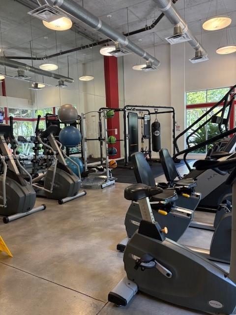 workout area with visible vents and a high ceiling