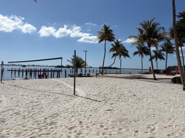 surrounding community featuring a water view and volleyball court
