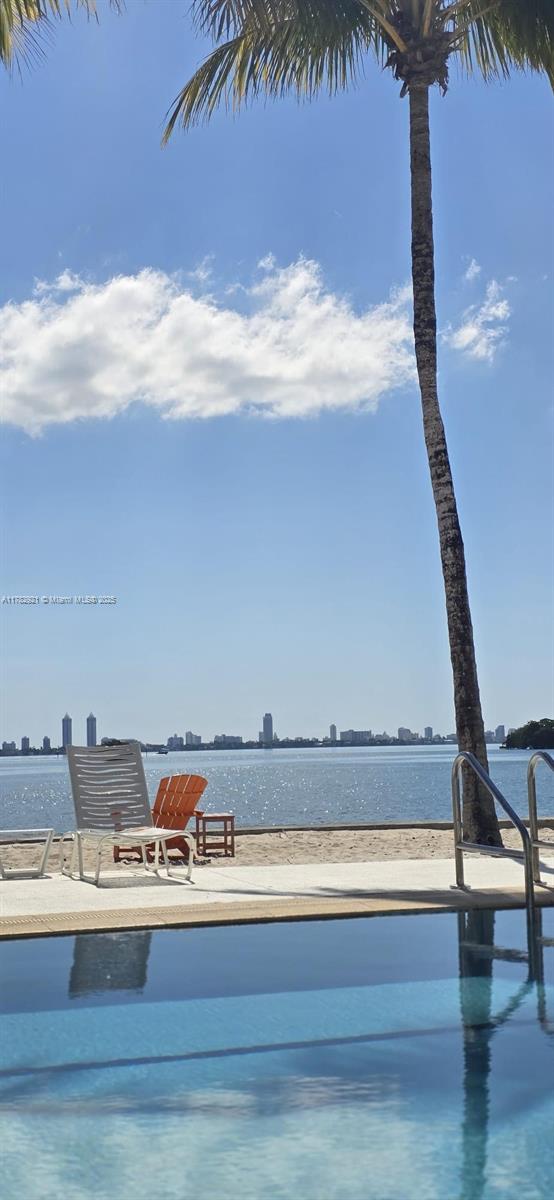 view of pool with a water view