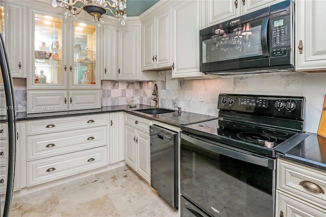 1811 Jefferson St Unit 203, Hollywood, FL 33020 - kitchen featuring black appliances, a sink, dark countertops, and tasteful backsplash
