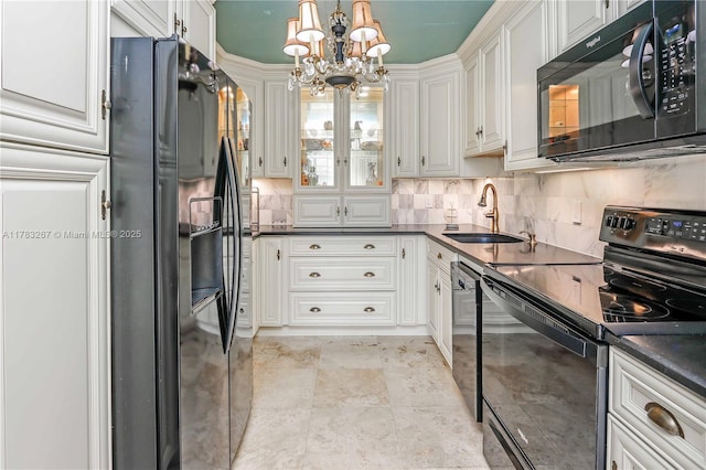 1811 Jefferson St Unit 203, Hollywood, FL 33020 - kitchen with black appliances, a sink, dark countertops, and a chandelier