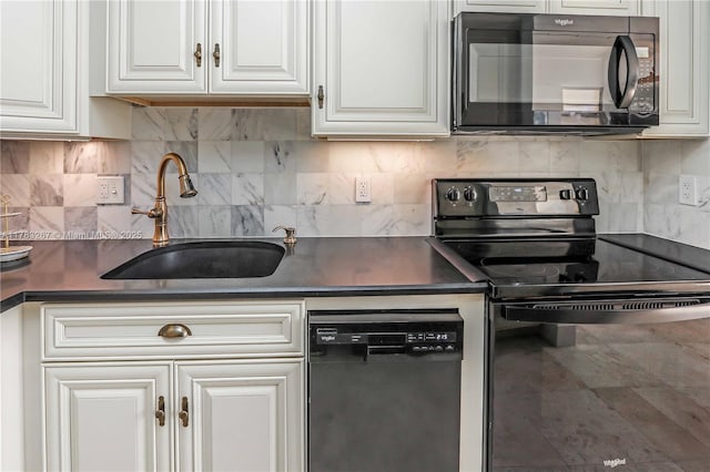 1811 Jefferson St Unit 203, Hollywood, FL 33020 - kitchen featuring black appliances, a sink, dark countertops, and white cabinets