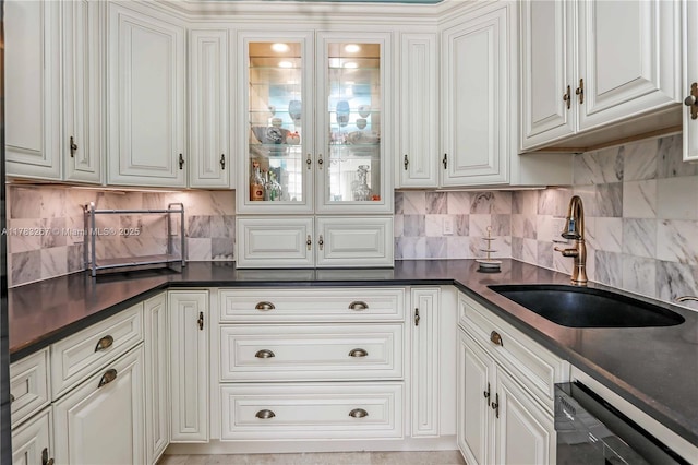 1811 Jefferson St Unit 203, Hollywood, FL 33020 - kitchen with black dishwasher, a sink, dark countertops, and decorative backsplash