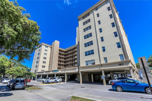 1811 Jefferson St Unit 203, Hollywood, FL 33020 - view of apartment building / complex with covered and uncovered parking and view of commercial area