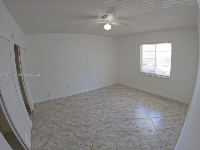 525 Meridian Ave Unit 105, Miami Beach, FL 33139 - empty room with ceiling fan, light tile patterned flooring, baseboards, and a textured ceiling