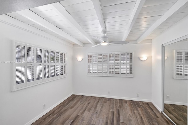 empty room featuring baseboards, a ceiling fan, wood ceiling, beamed ceiling, and wood finished floors