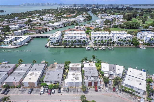 drone / aerial view with a city view and a water view