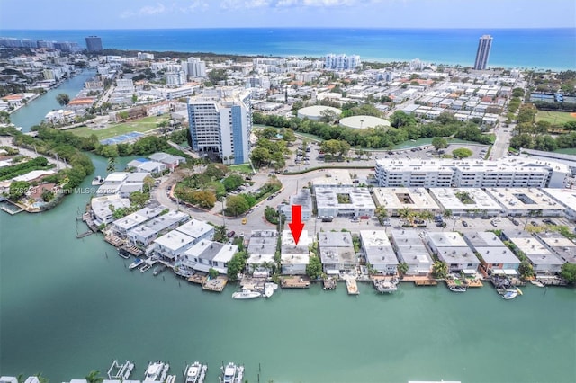 birds eye view of property with a water view and a view of city