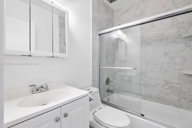 full bath with bath / shower combo with glass door, vanity, and toilet