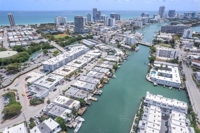 birds eye view of property with a water view and a city view