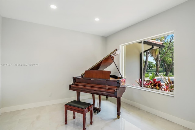 living area featuring baseboards and recessed lighting