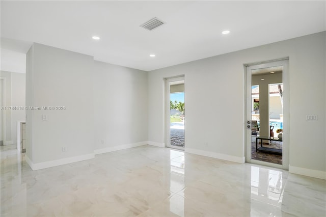 unfurnished room with recessed lighting, visible vents, and baseboards