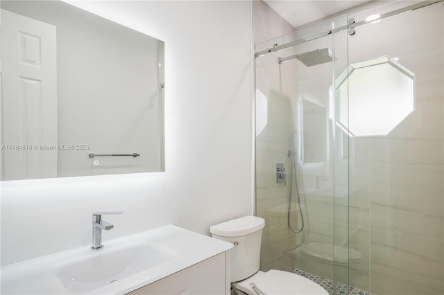 full bathroom with toilet, a shower stall, and vanity