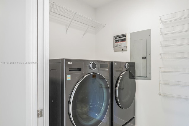 laundry room with washer and dryer, laundry area, and electric panel