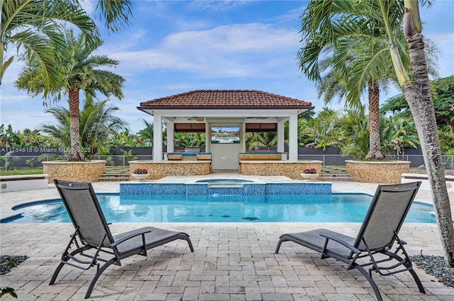 view of swimming pool featuring an in ground hot tub, a gazebo, fence, and a fenced in pool