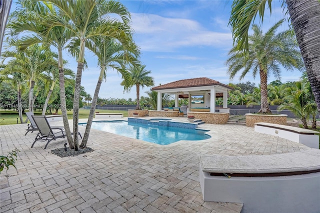 outdoor pool with a gazebo, a patio area, fence, and an in ground hot tub
