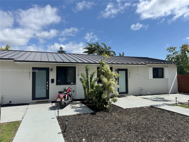 1021 NE 110th St, Biscayne Park, FL 33161 - ranch-style home with a standing seam roof, stucco siding, and metal roof