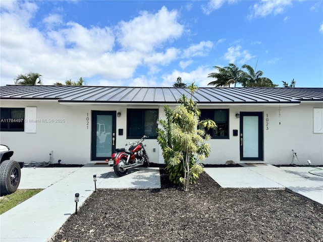 1021 NE 110th St, Biscayne Park, FL 33161 - ranch-style home with a standing seam roof, metal roof, and stucco siding