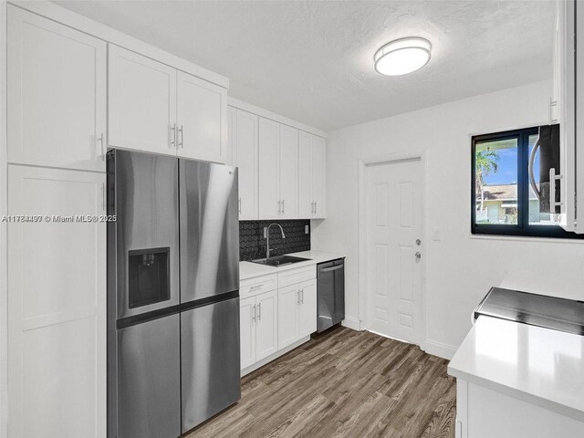 1021 NE 110th St, Biscayne Park, FL 33161 - kitchen featuring a sink, appliances with stainless steel finishes, dark wood-style flooring, and light countertops