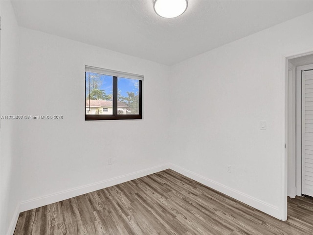1021 NE 110th St, Biscayne Park, FL 33161 - empty room with baseboards and wood finished floors