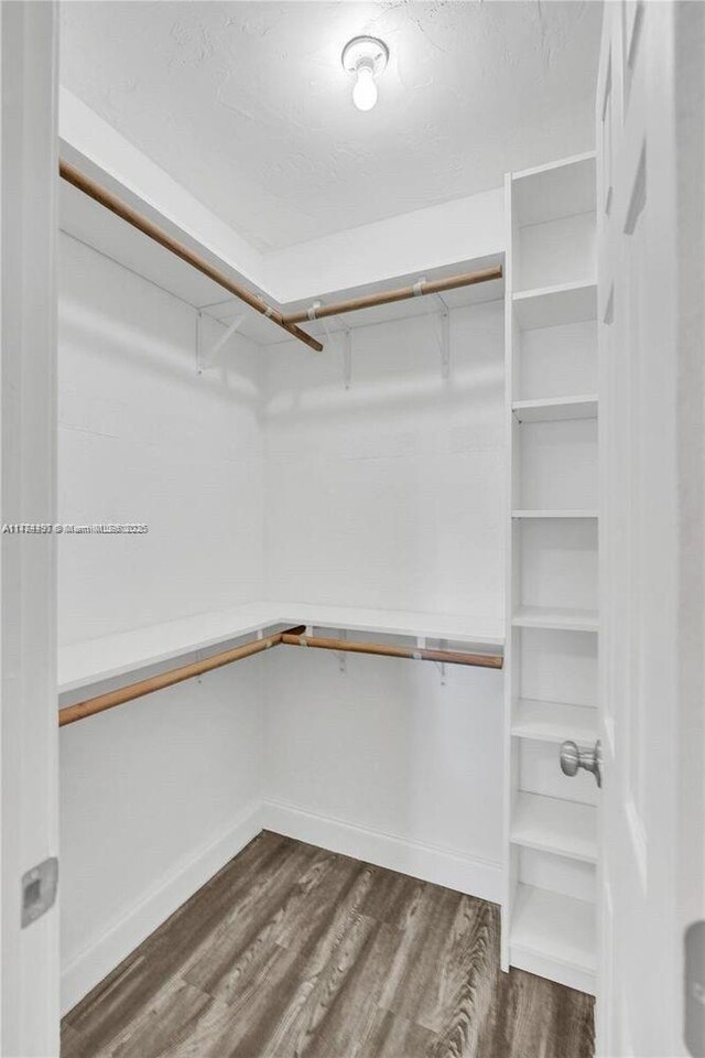1021 NE 110th St, Biscayne Park, FL 33161 - walk in closet featuring dark wood-style flooring
