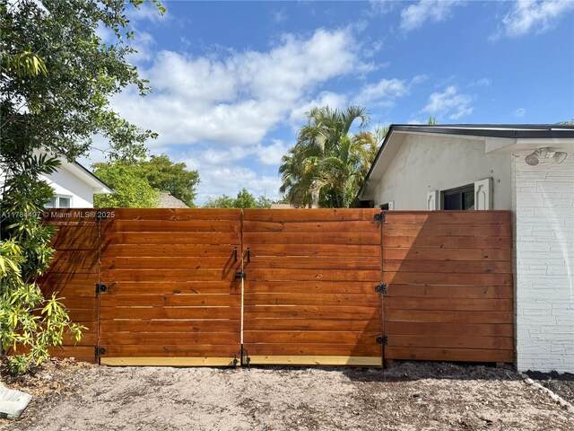 1021 NE 110th St, Biscayne Park, FL 33161 - view of gate featuring fence