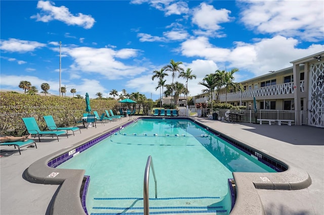community pool featuring a patio area and fence