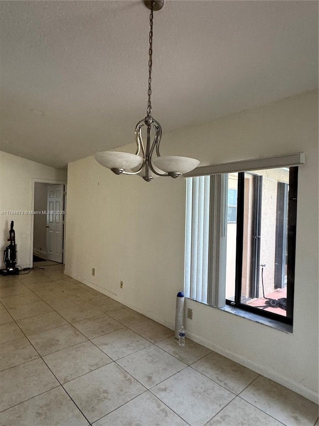 900 Atlantic Shores Blvd Unit 126, Hallandale Beach, FL 33009 - spare room with a chandelier, light tile patterned floors, a textured ceiling, and baseboards