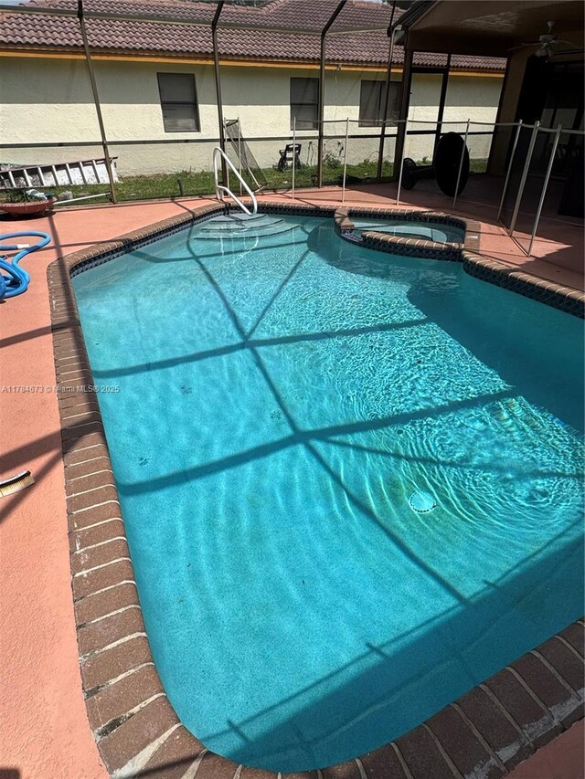 900 Atlantic Shores Blvd Unit 126, Hallandale Beach, FL 33009 - view of pool featuring a pool with connected hot tub, a patio area, and glass enclosure