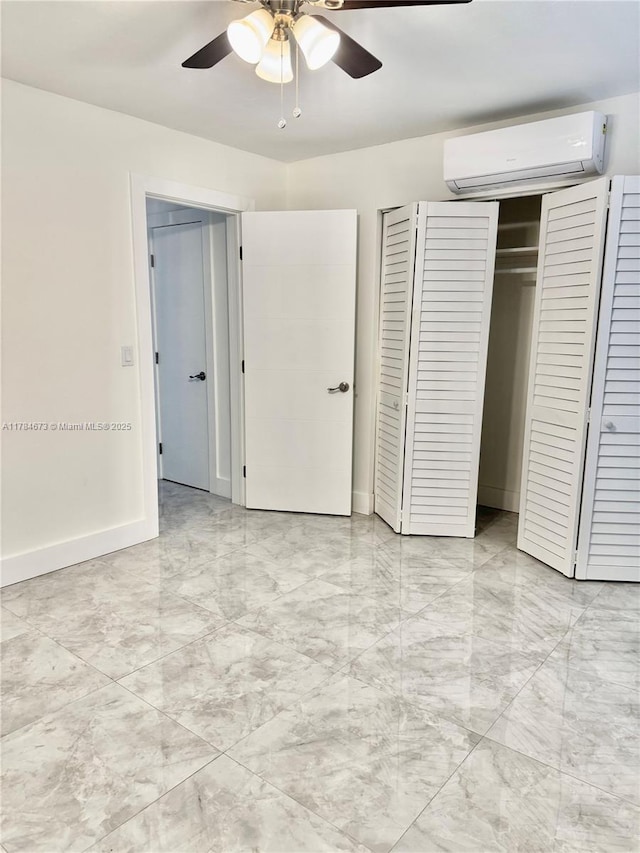 900 Atlantic Shores Blvd Unit 126, Hallandale Beach, FL 33009 - unfurnished bedroom with an AC wall unit, light marble finish flooring, a closet, baseboards, and ceiling fan