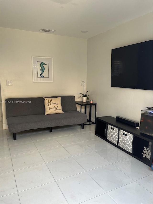 living area with light tile patterned flooring and visible vents