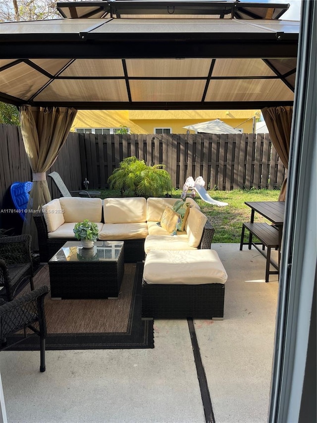 view of patio / terrace with a fenced backyard, outdoor lounge area, and a gazebo